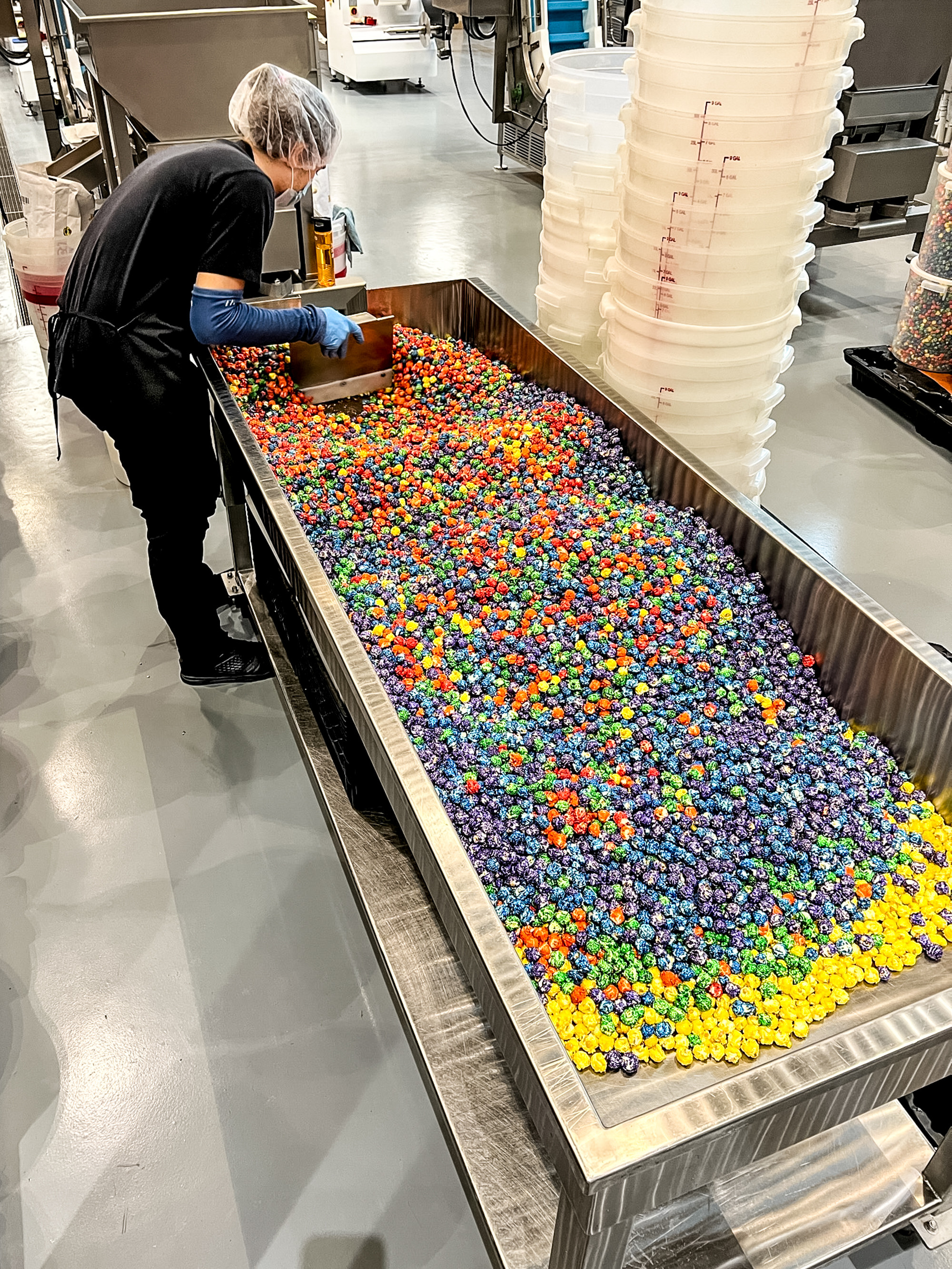 employee sorting multicolored popcorn